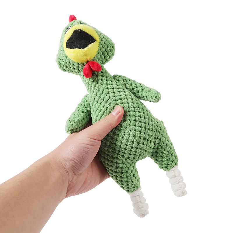 Hand holding a green crochet dinosaur toy with a red bow tie on a white background