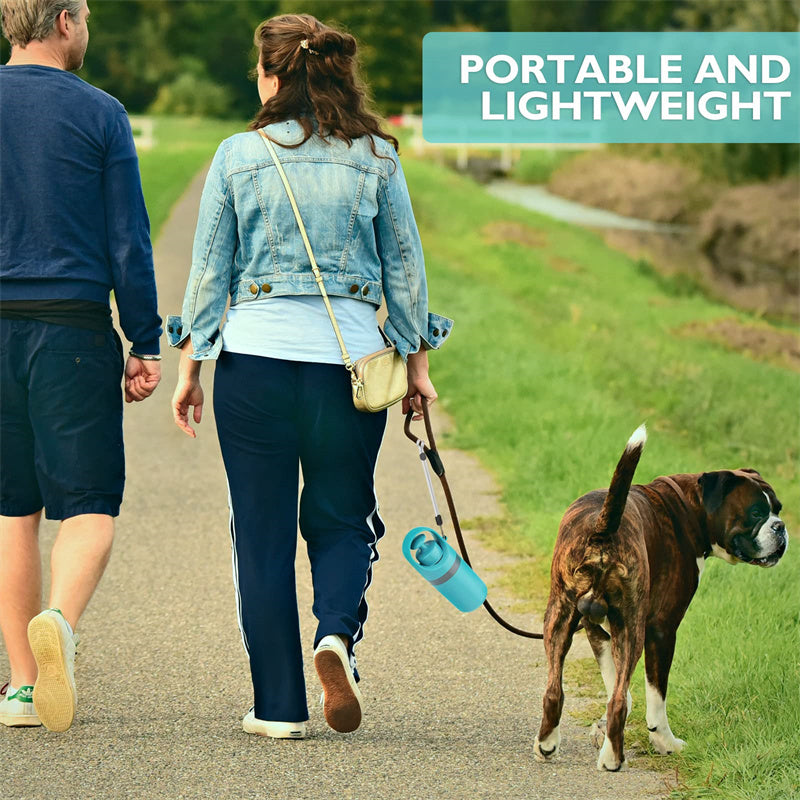 Couple walking dog with portable lightweight dog pooper scooper attached to leash