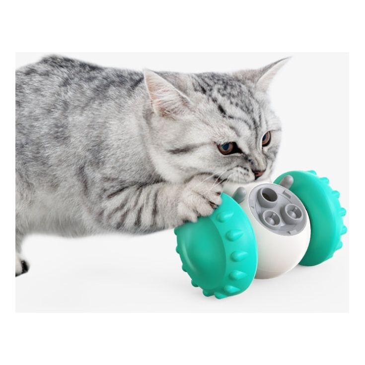 Cat playing with interactive treat dispenser toy – smart rolling tumbler for cats that releases food when pushed, promotes exercise and mental stimulation