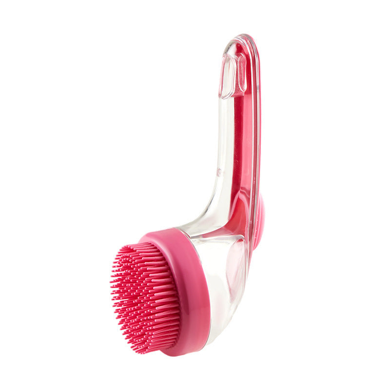Pink and clear scrubbing brush on a white background
