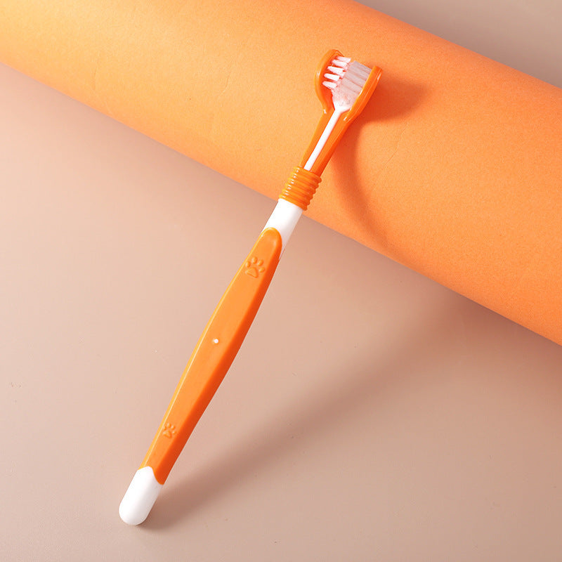 Orange pet toothbrush with paw design – double-headed dental brush for pets.