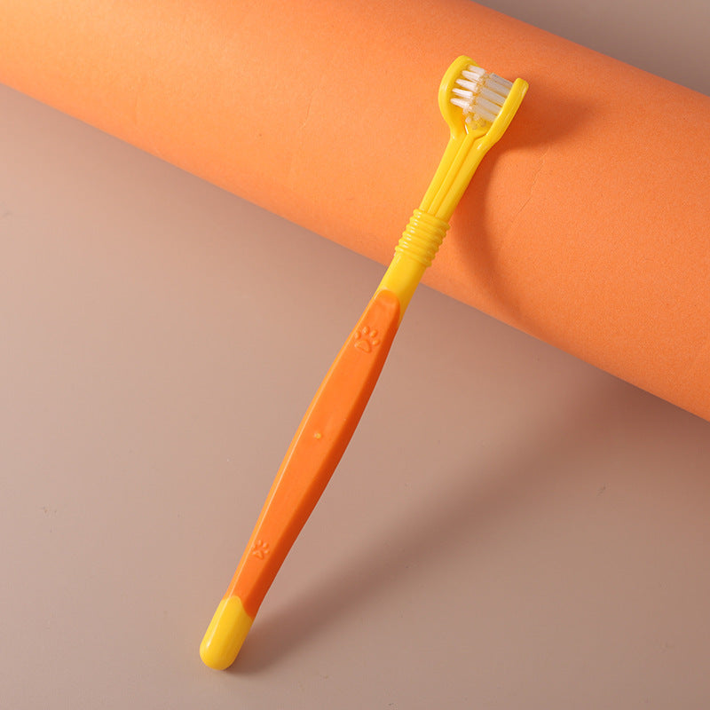 Yellow pet toothbrush with paw design – dental care tool for dogs and cats.