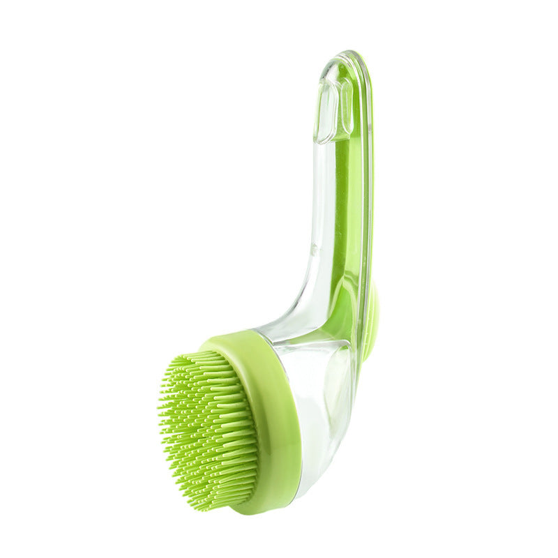 Green kitchen brush with clear handle on a white background
