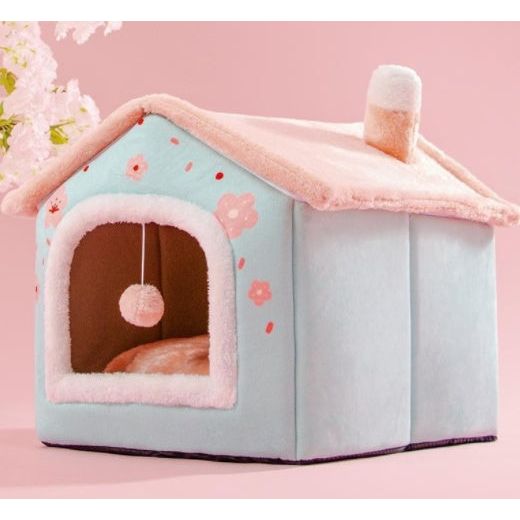 Light blue and pink plush pet house with flower design, chimney, and hanging ball toy – cozy indoor bed for cats and small dogs.
