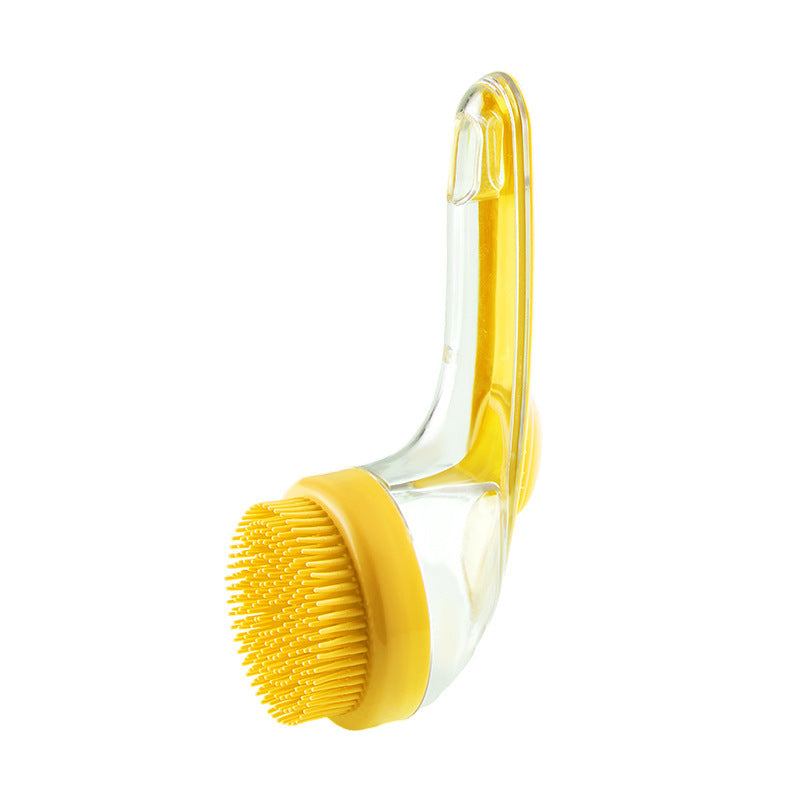 Yellow scrub brush with clear handle on a white background
