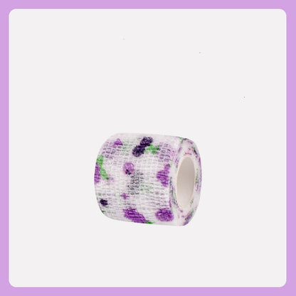Roll of bandage with purple and green floral pattern on a white background