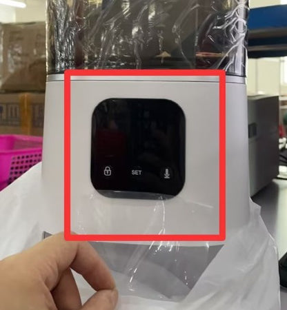 White electronic device with a screen, held by a hand, in a partially transparent plastic bag.