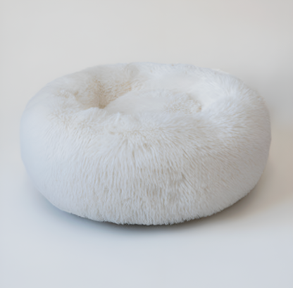 White fluffy donut-shaped pet bed on a light background